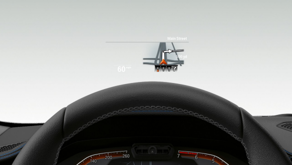 BMW Série 3 Berline, Head-Up Display. Gros plan frontal à travers le pare-brise montrant un demi-volant de la BMW Série 3 Berline avec Head-Up Display.