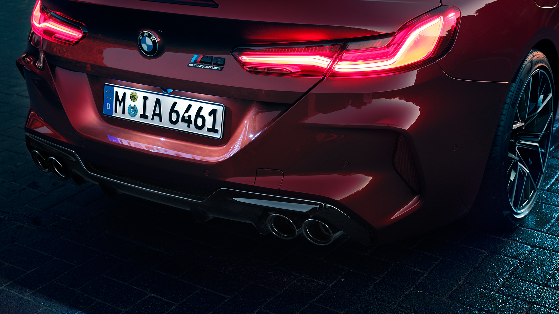 BMW M8 Competition Cabriolet, vue en gros plan de l’arrière F91. BMW M8 Competition Cabriolet en Motegi Rot metallic, vue en gros plan de l’arrière avec feux arrière à LED et badge M8 Competition F91.