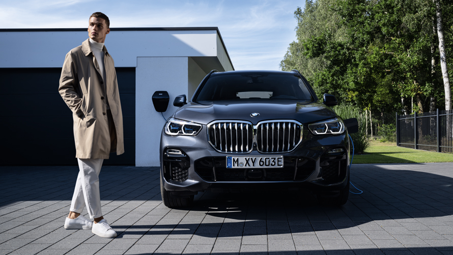 BMW X5 Hybride Rechargeable blanc en dynamique sous un pont BMW X5 Hybride Rechargeable blanc en dynamique sous un pont